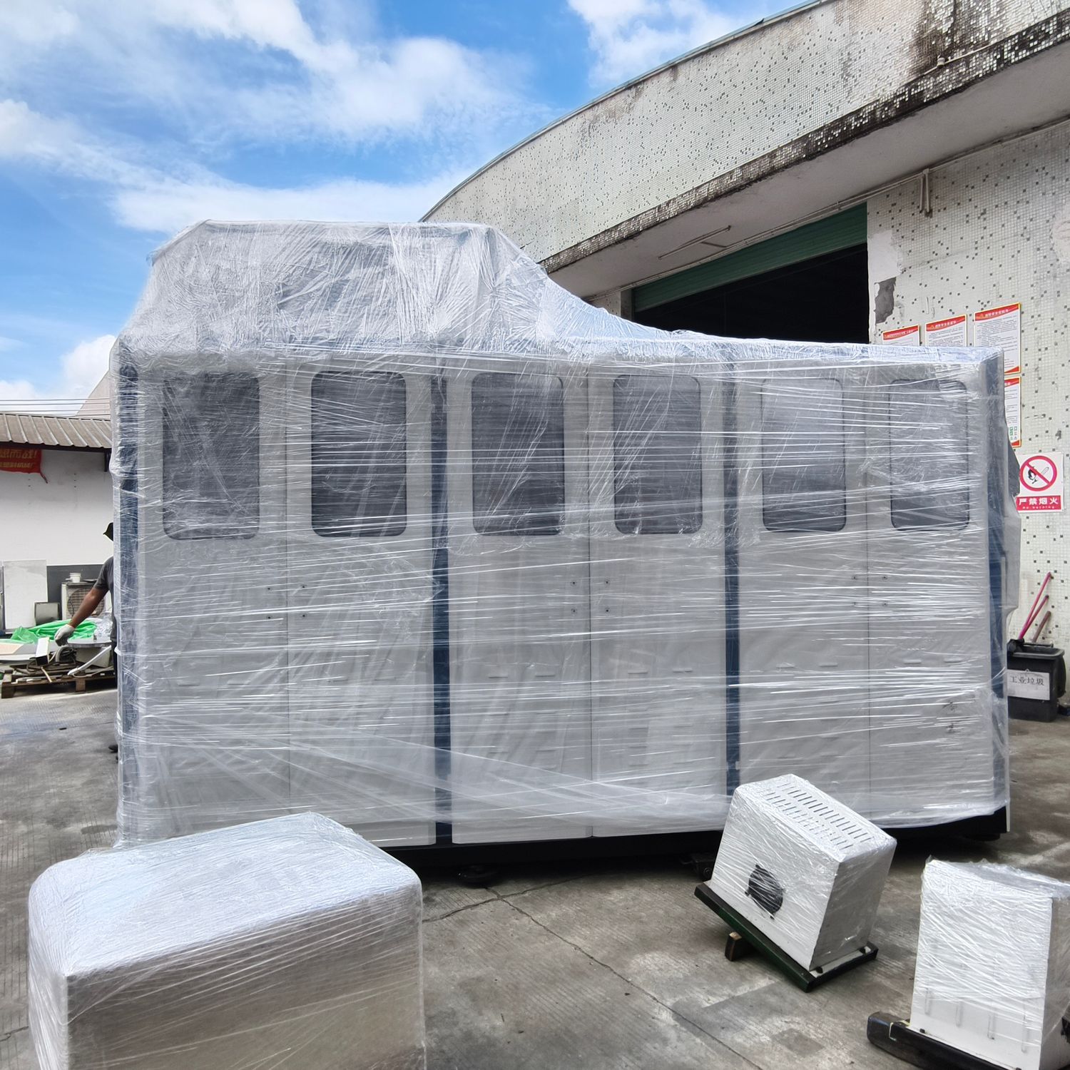 Plastic cup making machine wrapped in stretch film on the loading yard before container loading